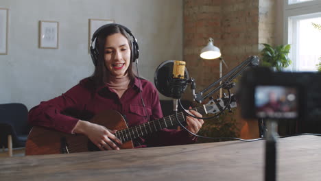 Young-Female-Musician-Filming-Online-Guitar-Class-in-Studio
